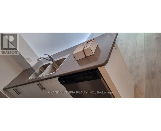 A kitchen with a sink and a dishwasher.