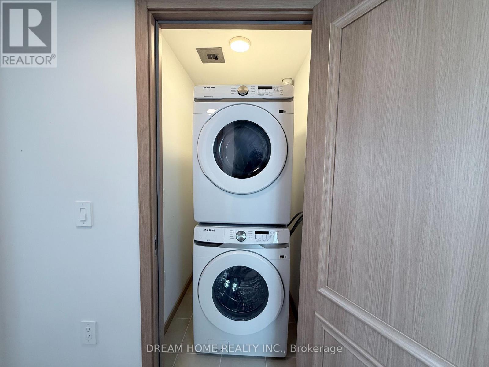 A washer and dryer are stacked in a small space.
