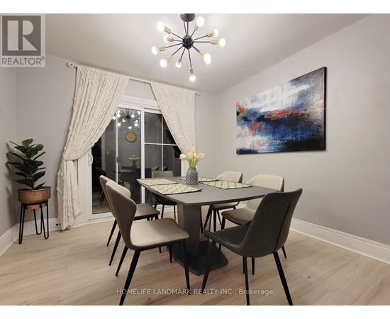 A dining room with a table set for two and a painting on the wall.
