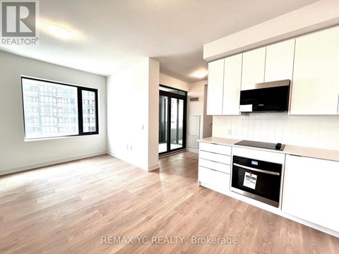 A kitchen with white cabinets and a black oven.