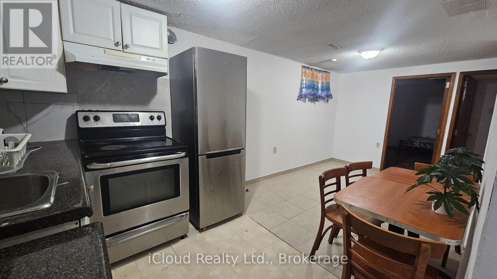 A kitchen with a stove, oven, and refrigerator.