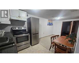 A kitchen with a stove, oven, and refrigerator.
