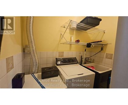 A small laundry room with a washer and dryer.