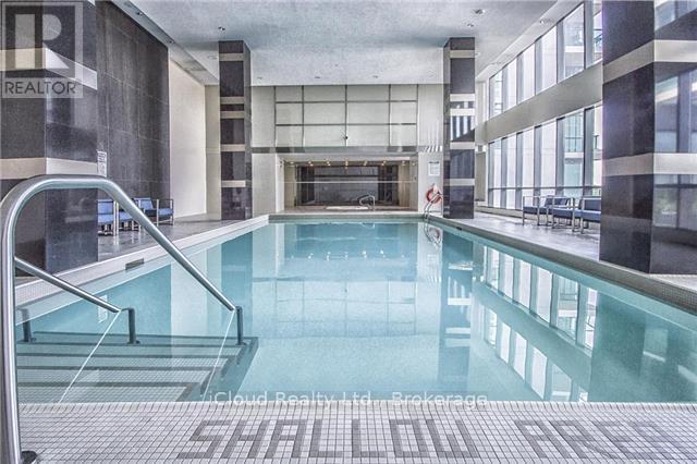 A large indoor swimming pool with a glass bottom.