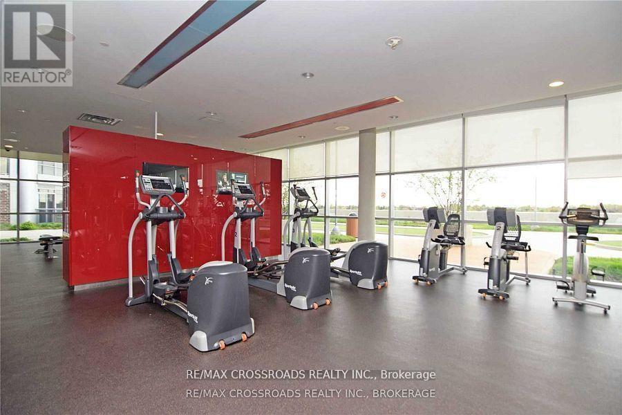 A gym with a red wall and various exercise equipment.