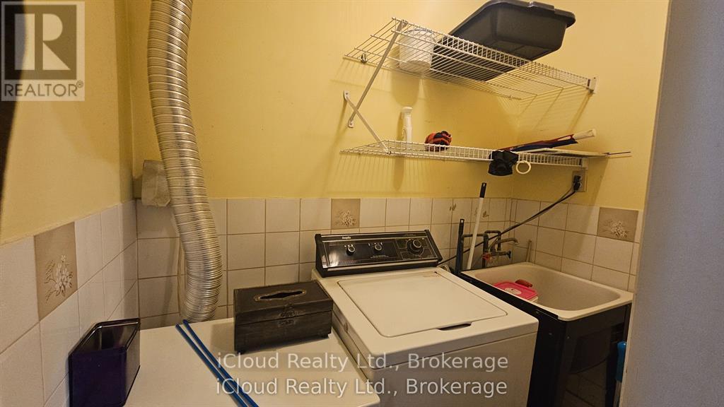 A small laundry room with a washer and dryer.