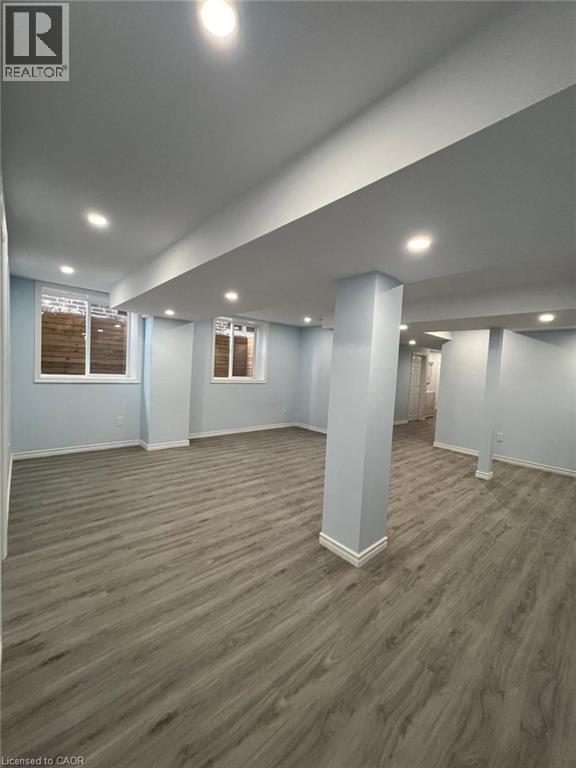 A room with wooden flooring and white walls.