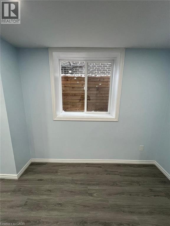 A room with a window and wooden blinds.