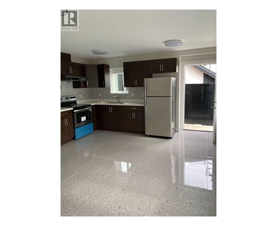 A kitchen with brown cabinets and a white fridge.