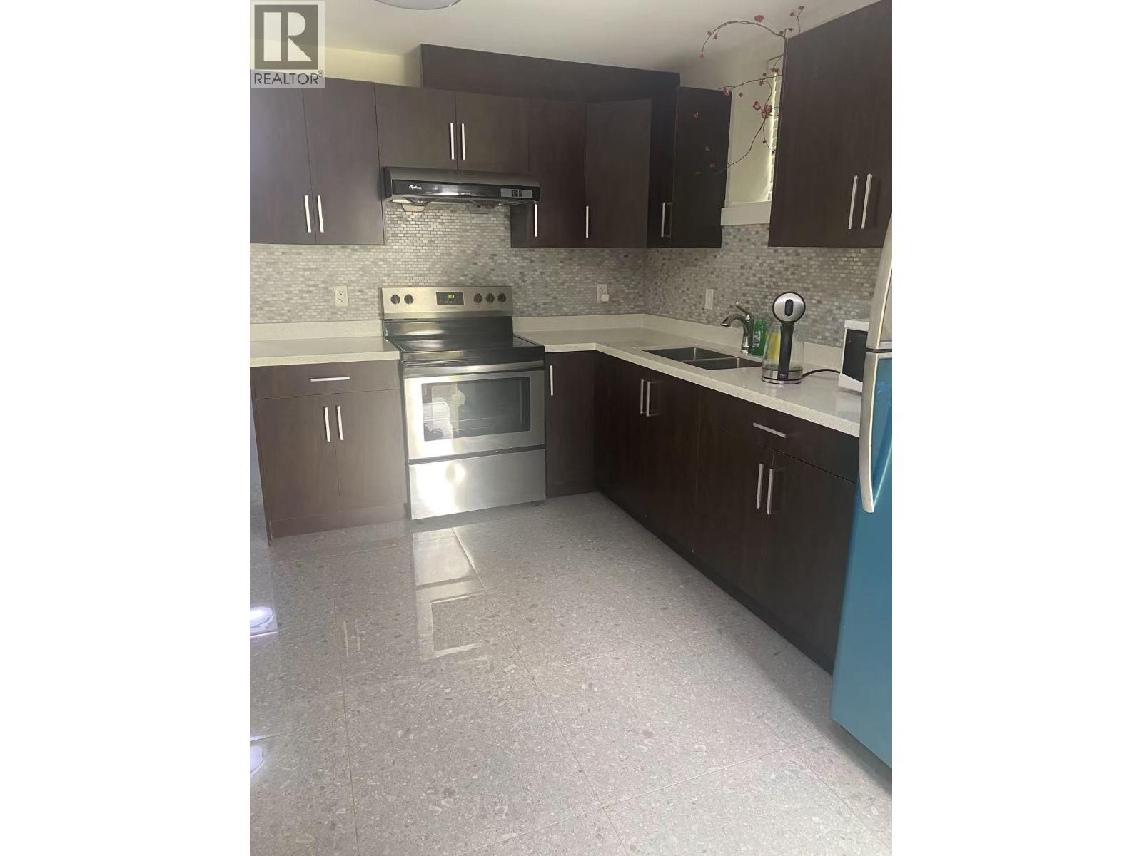 A kitchen with a stove top oven and a dishwasher.