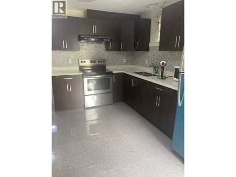 A kitchen with a stove top oven and a dishwasher.