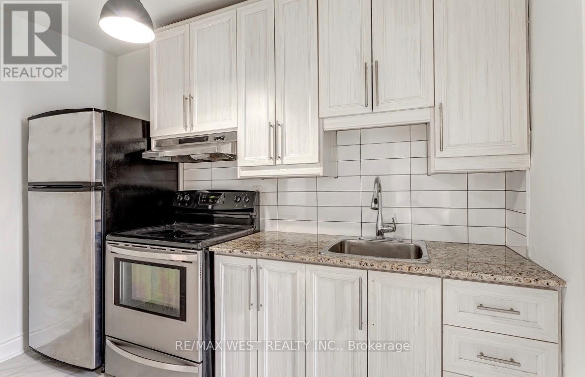 A kitchen with white cabinets and a granite countertop.