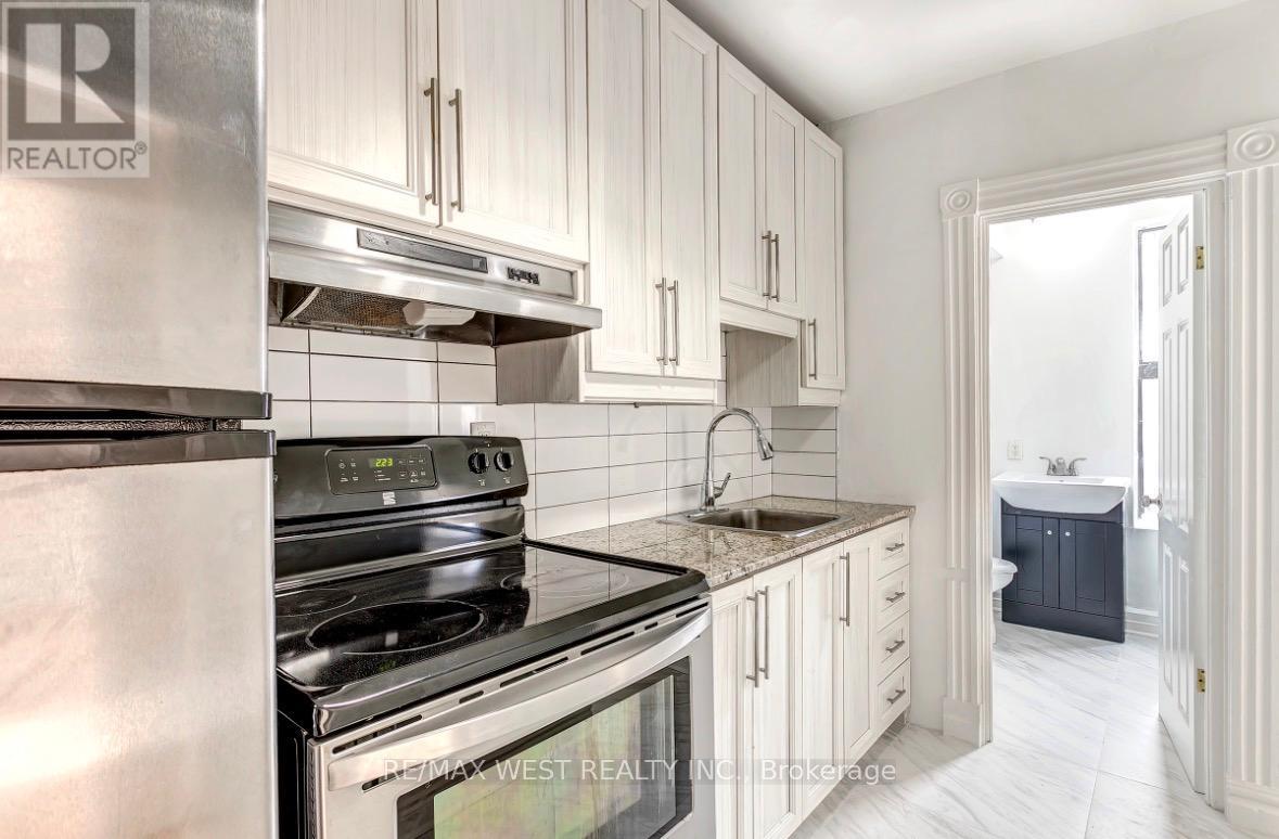 A kitchen with white cabinets and stainless steel appliances.