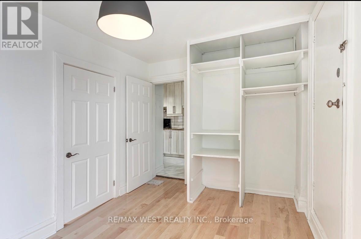 A white bedroom with a large open closet.