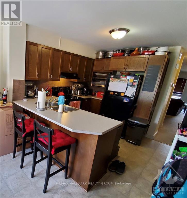 A kitchen with a white counter top and wooden cabinets.