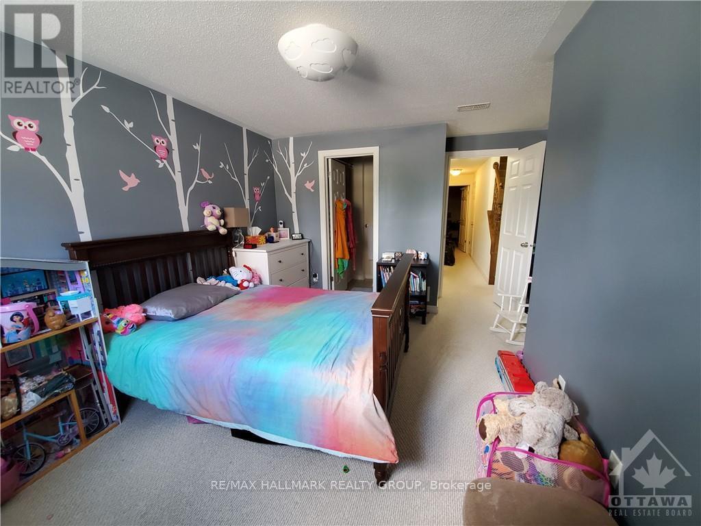 A bedroom with a bed, a dresser, and a bookshelf.