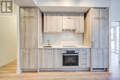 A kitchen with wooden cabinets and a stove top oven.