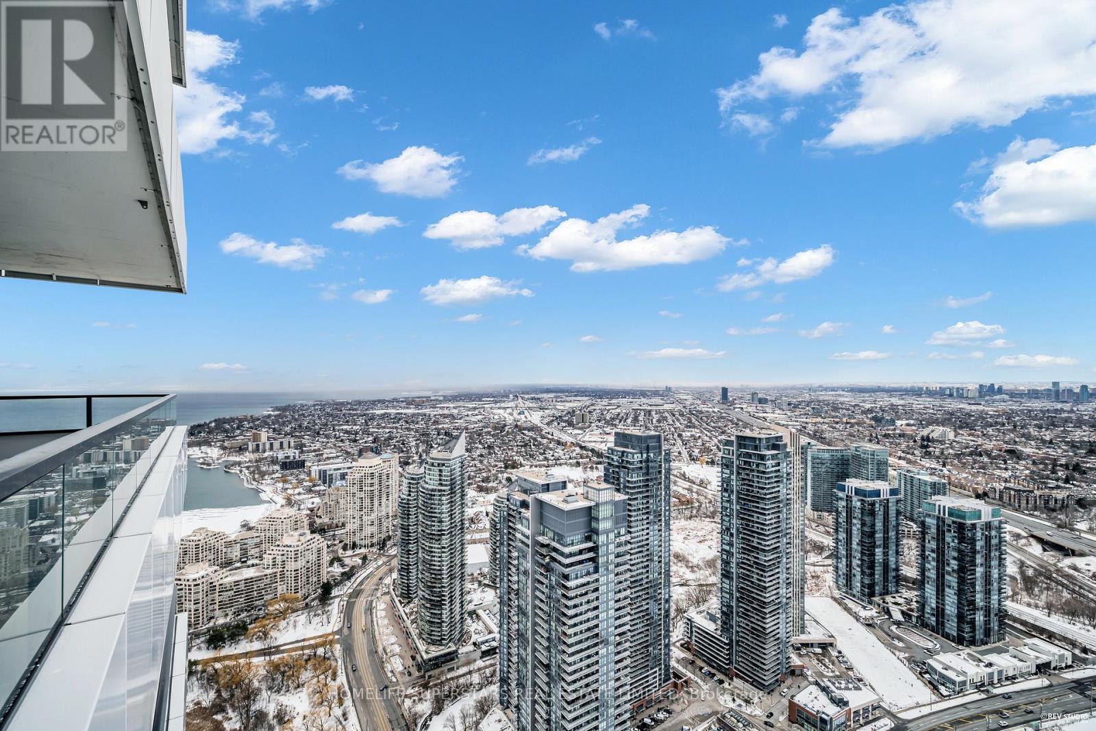 A view from a high-rise building showing a cityscape with a river and snow-covered ground.