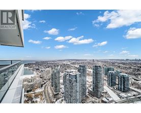 A view from a high-rise building showing a cityscape with a river and snow-covered ground.