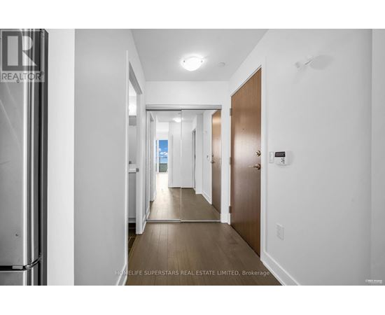 A hallway with a door on the right and a window in the distance.