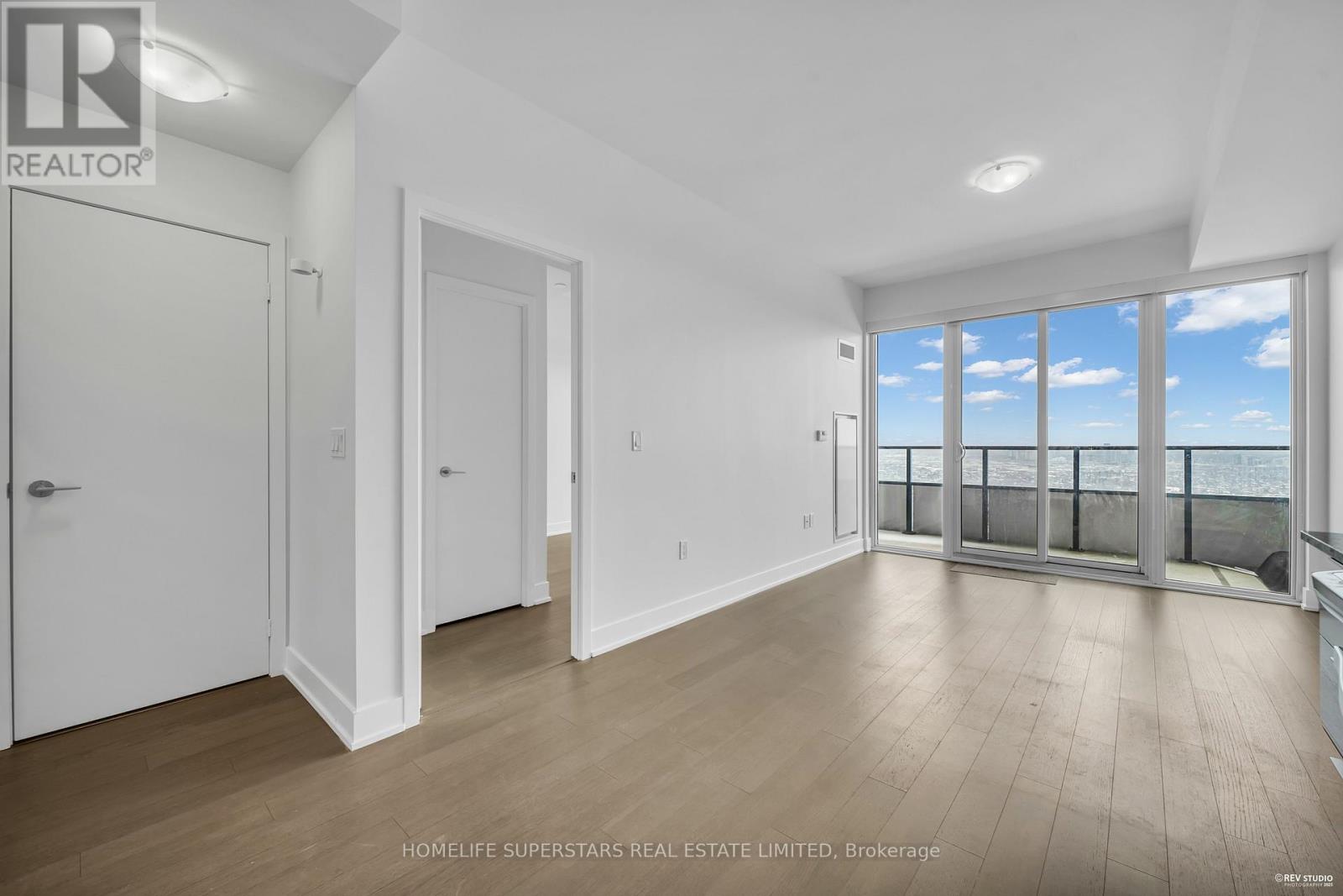A spacious room with a view of the sky through the windows.