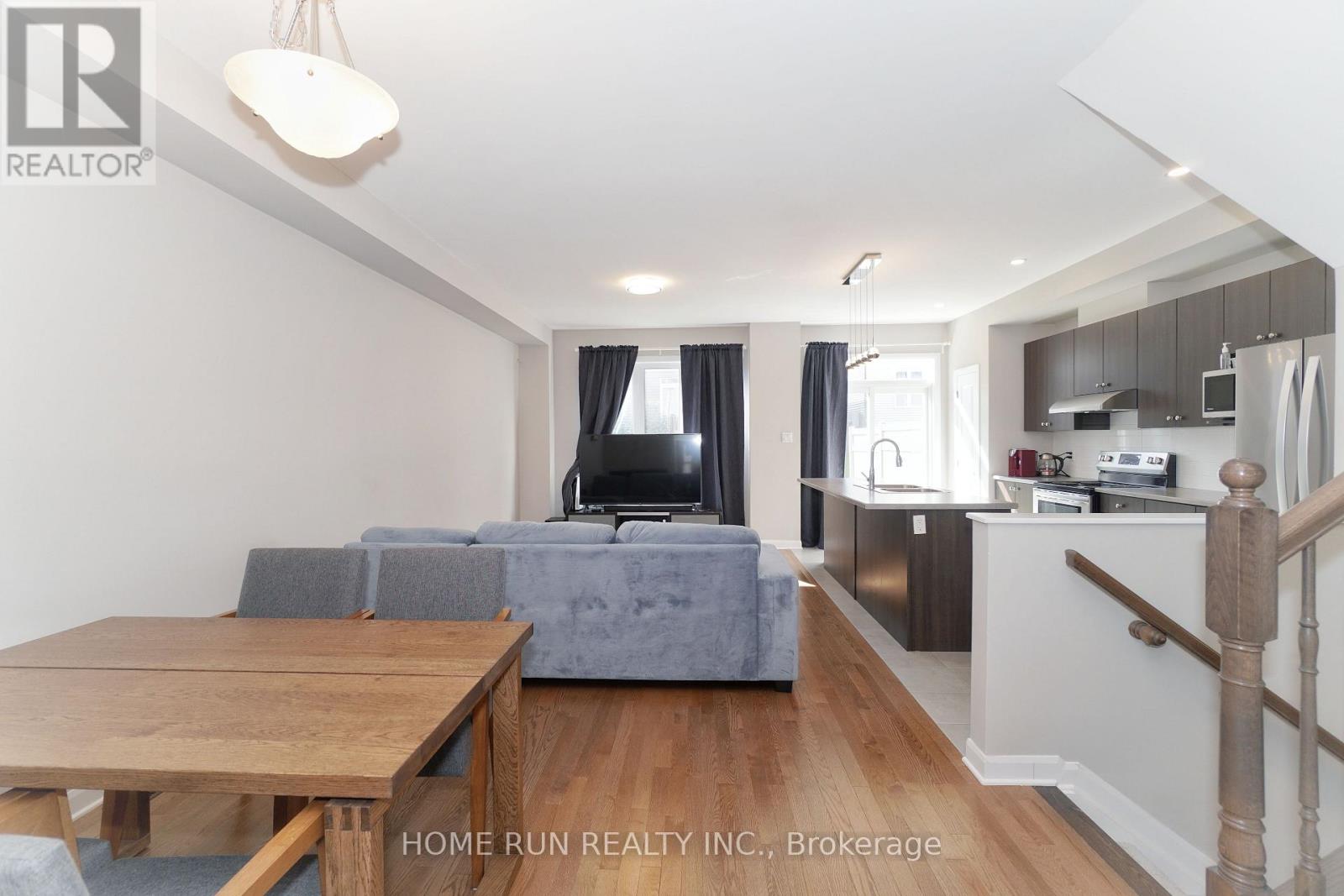 A living room with a grey couch and a wooden table.