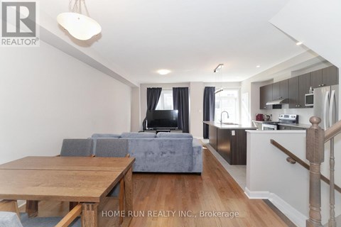 A living room with a grey couch and a wooden table.