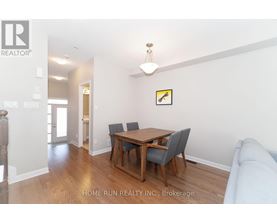 A dining room with a wooden table and chairs.