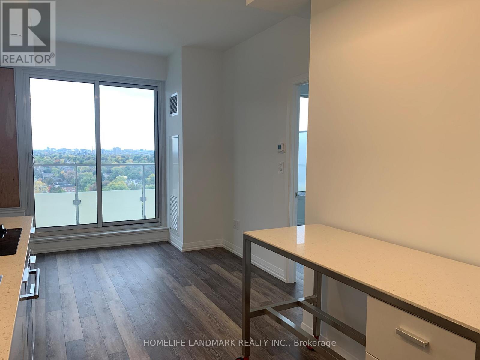 A room with a large window and a view of the city.