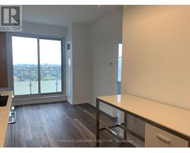 A room with a large window and a view of the city.