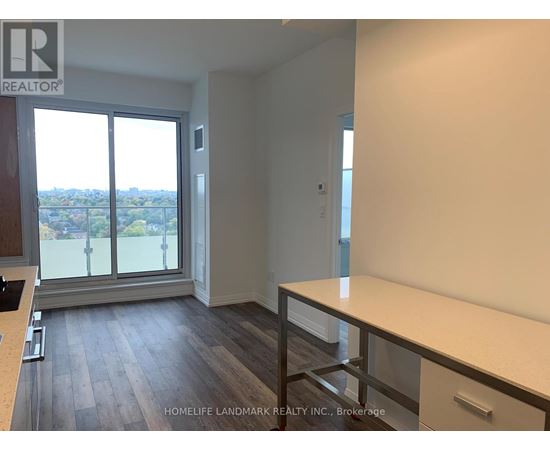 A room with a large window and a view of the city.