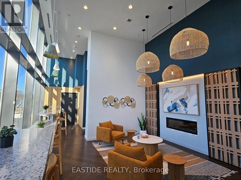 A modern living room with a fireplace and a large painting on the wall.