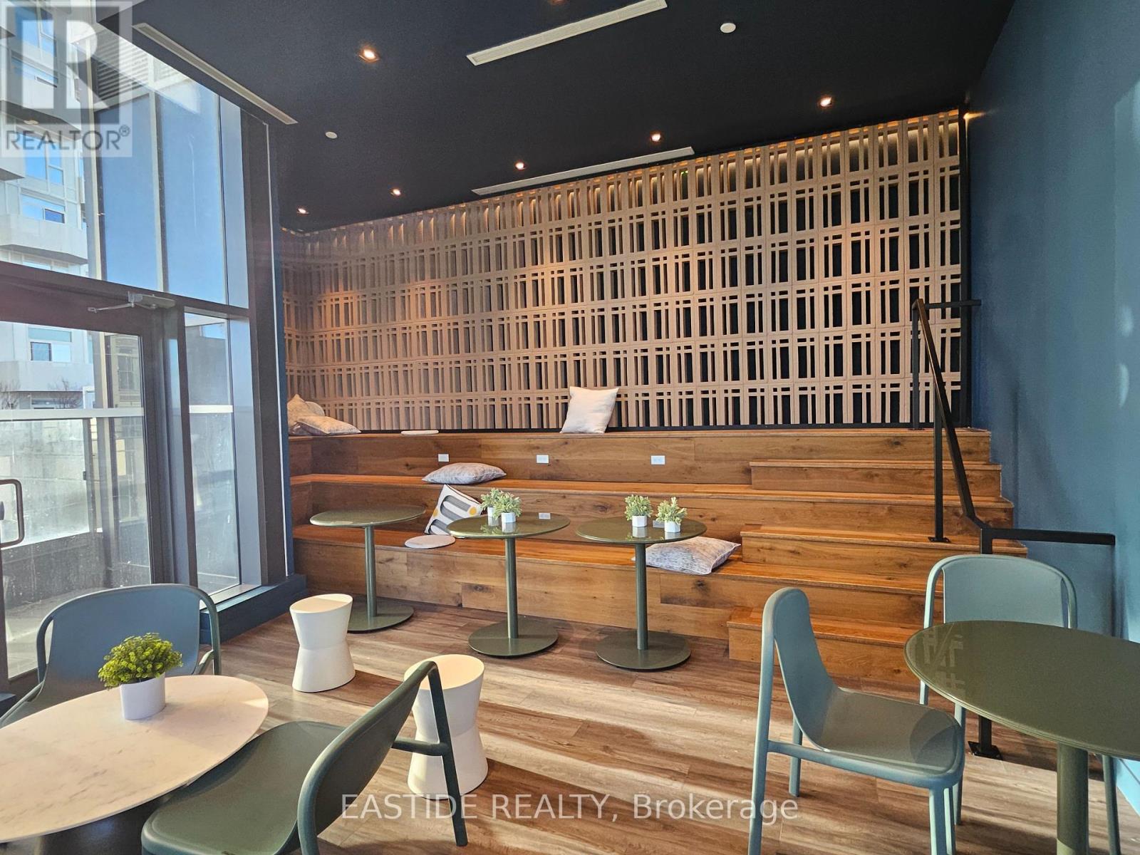 A modern dining area with wooden walls and furniture.