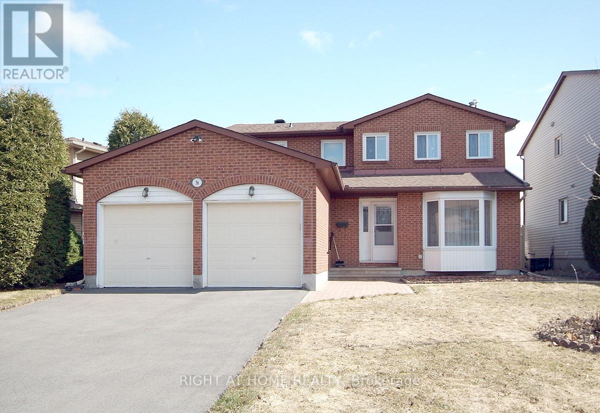 A two-story brick house with a garage is for sale.