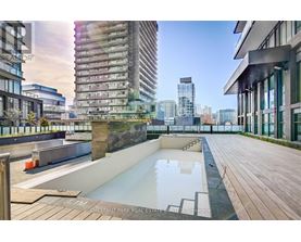 A rooftop pool area with a cityscape in the background.