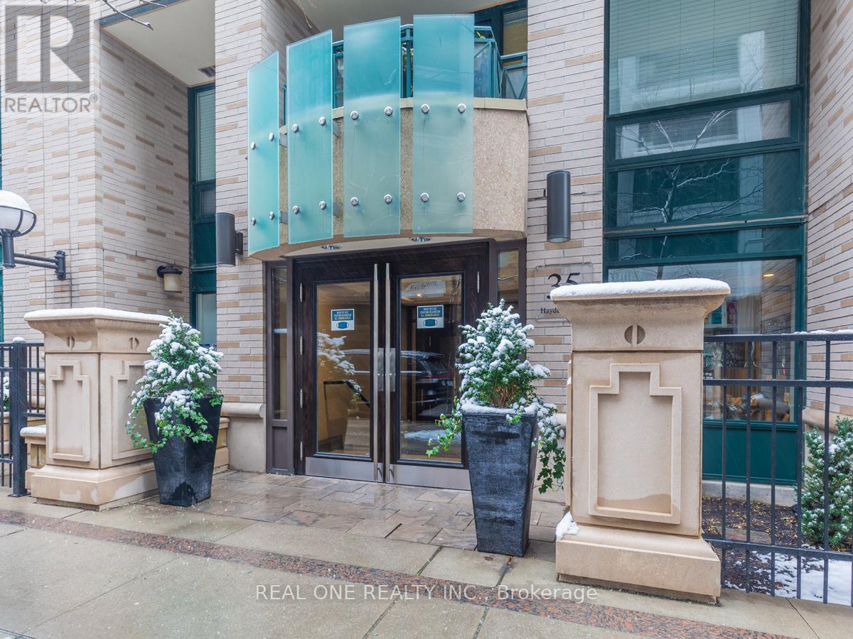 The front of a building with a glass door and a sign that says REAL ONE REALTY INC. Brokerage.