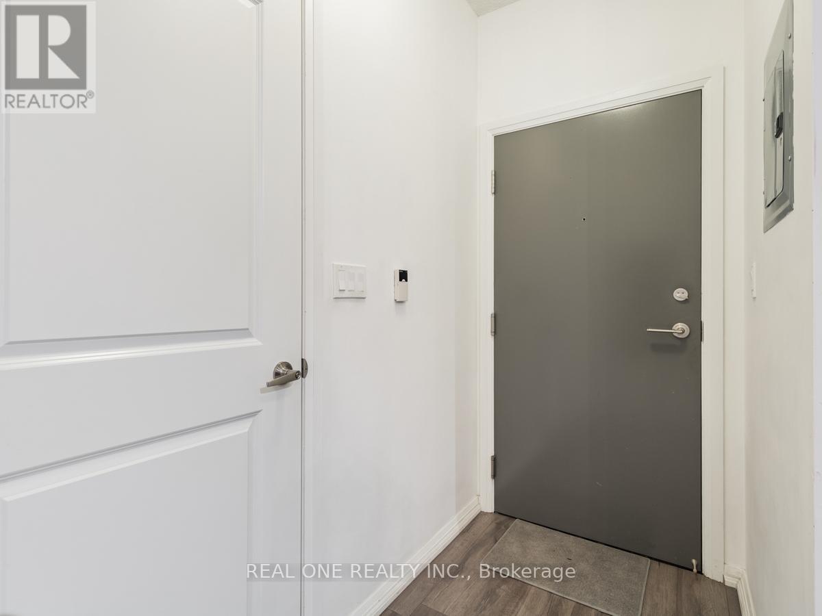 A hallway with a white door and a grey door.