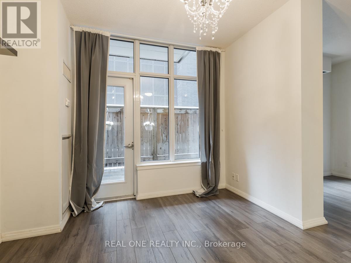 A room with a large window and a chandelier.