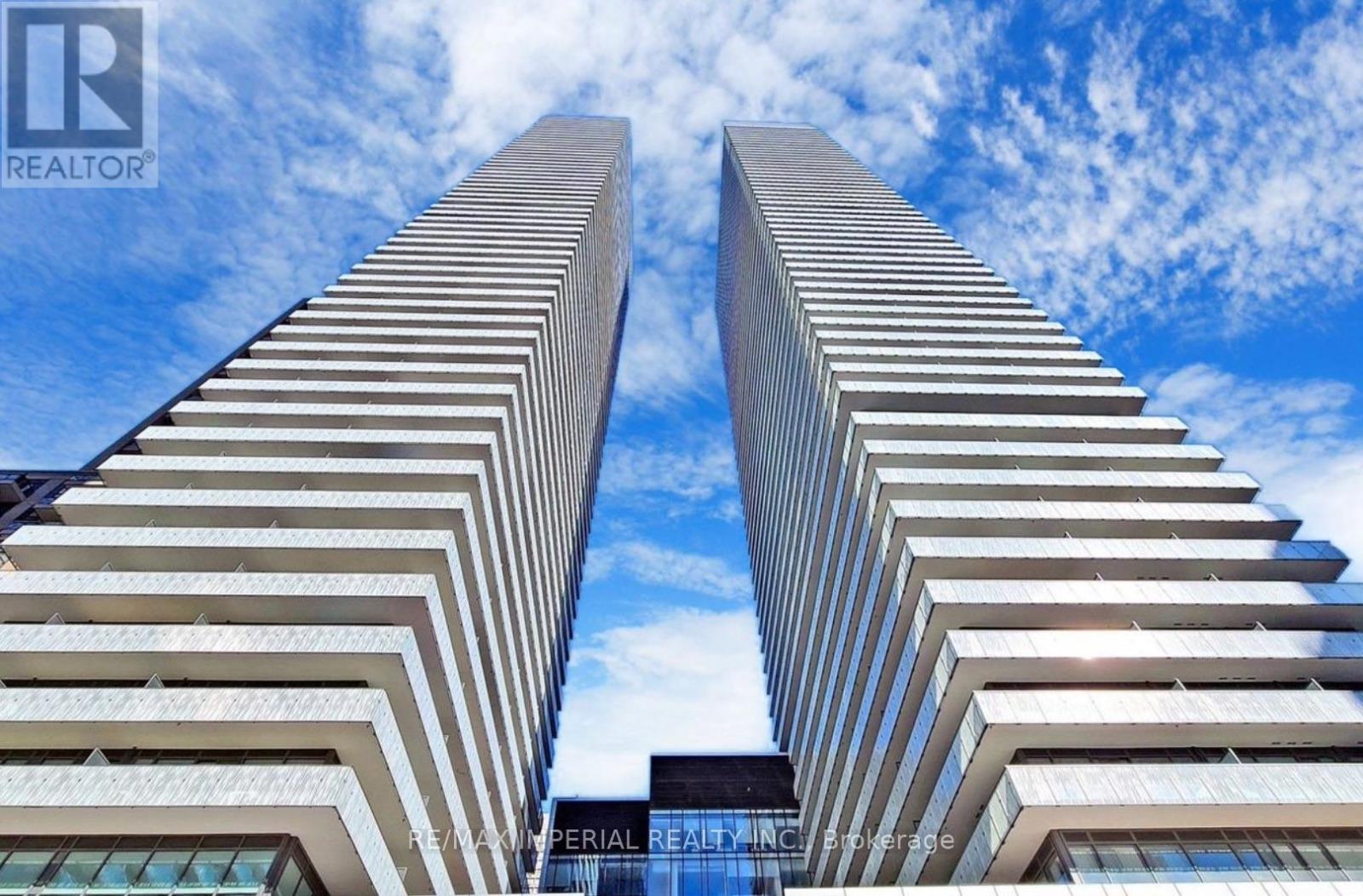 Two tall buildings with the logo REALTOR on the bottom.