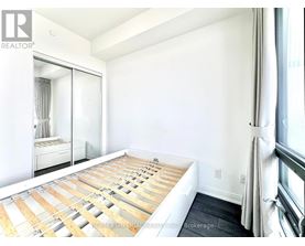 A bedroom with a bed in the middle of the room.