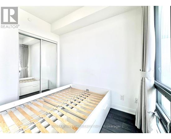 A bedroom with a bed in the middle of the room.