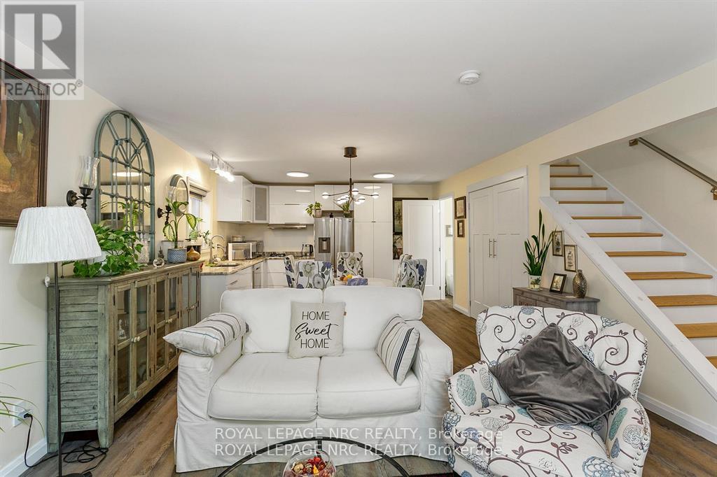 A living room with a white couch and a wooden cabinet.