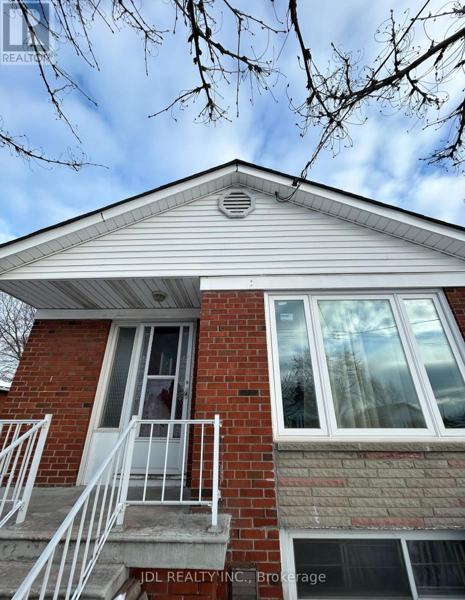 A house with a red brick wall and white trim.