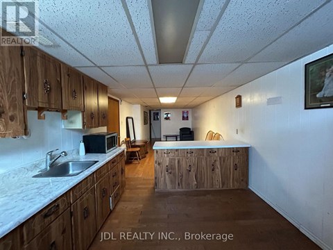 A kitchen with wooden cabinets and a white countertop.