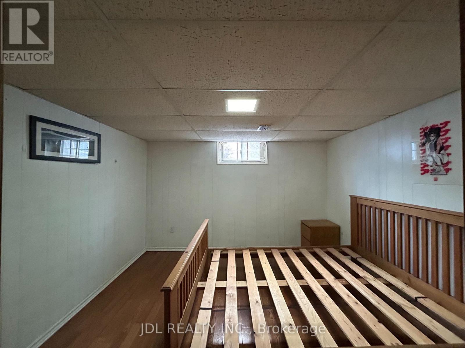A room with wooden flooring and a window.