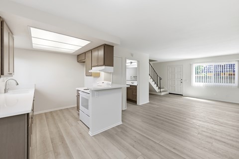 A kitchen with a sink, stove, and refrigerator.