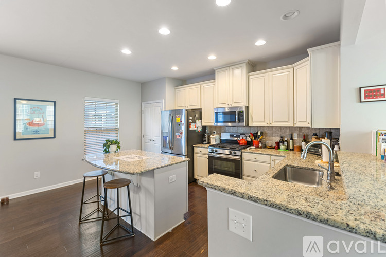 A kitchen with granite countertops and stainless steel appliances.
