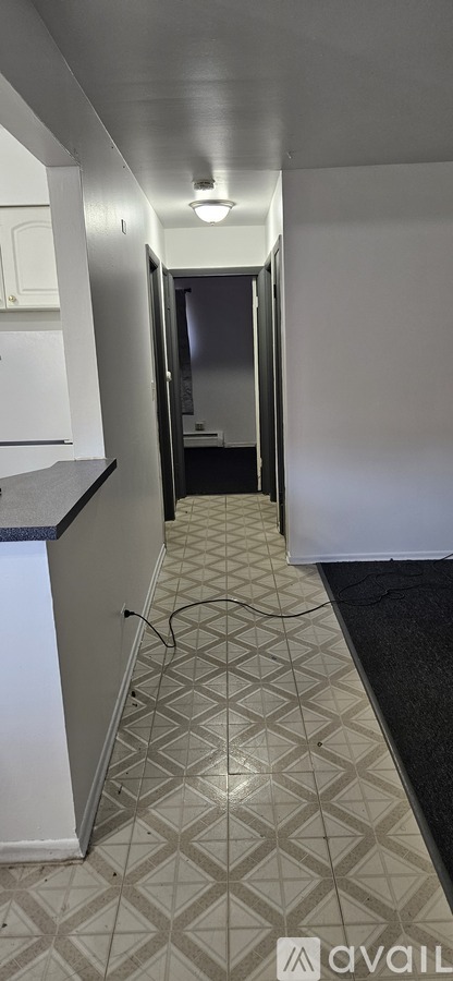 A hallway with a diamond patterned floor.