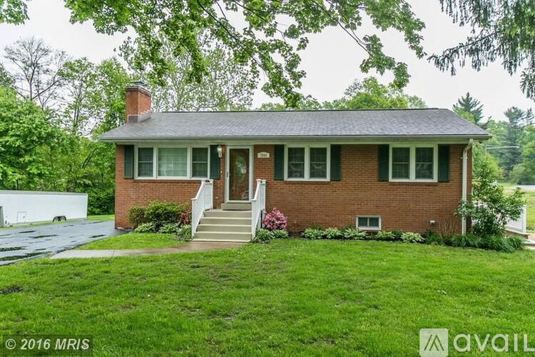 A house with a green lawn in front.
