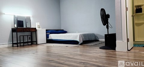 A bedroom with a bed, dresser, and mirror.